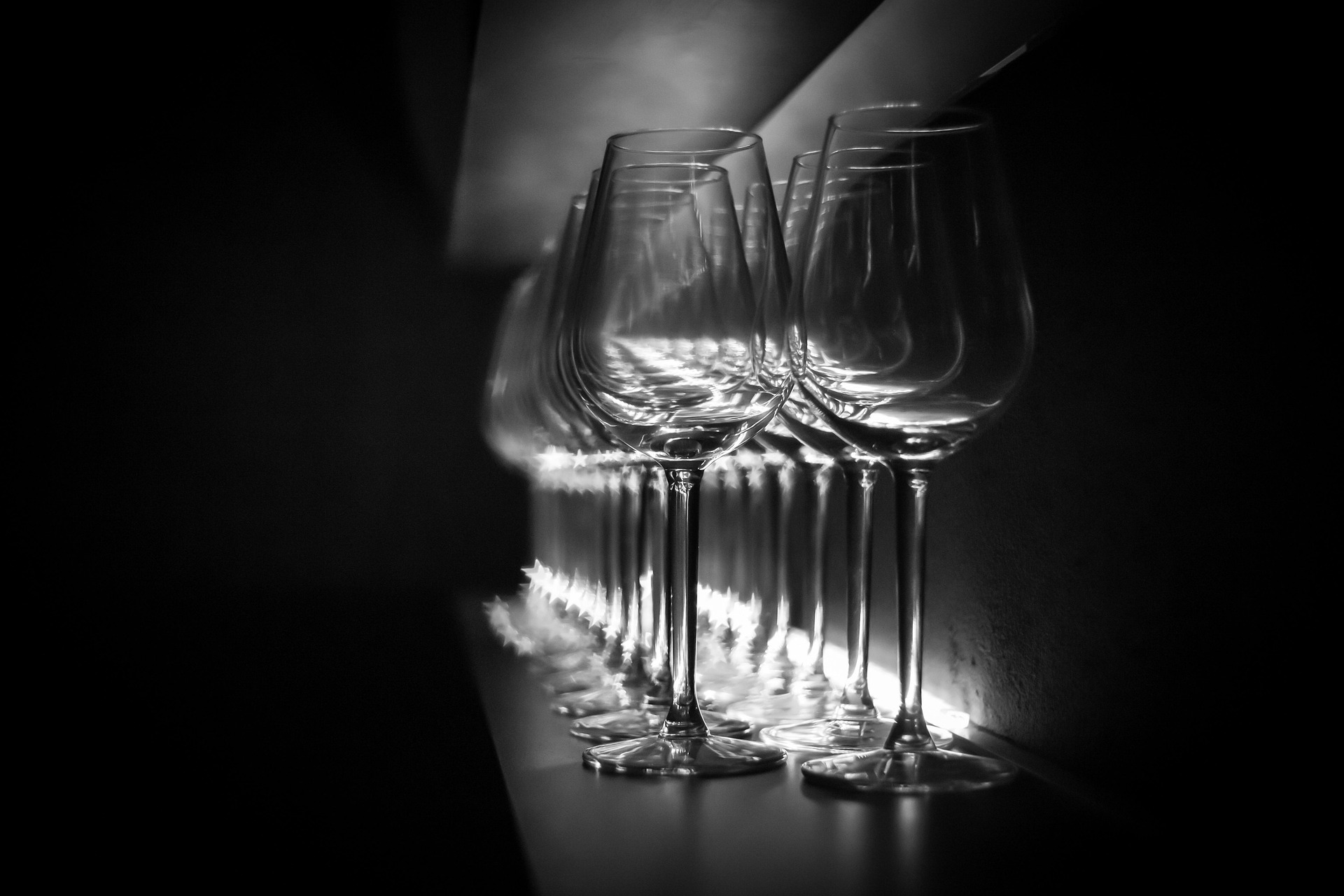 A low-lit wineglass with warm reflections.